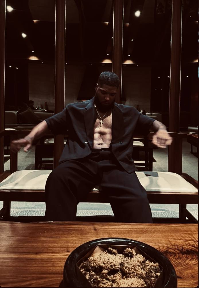 Lawrence seated in a low-lit lounge