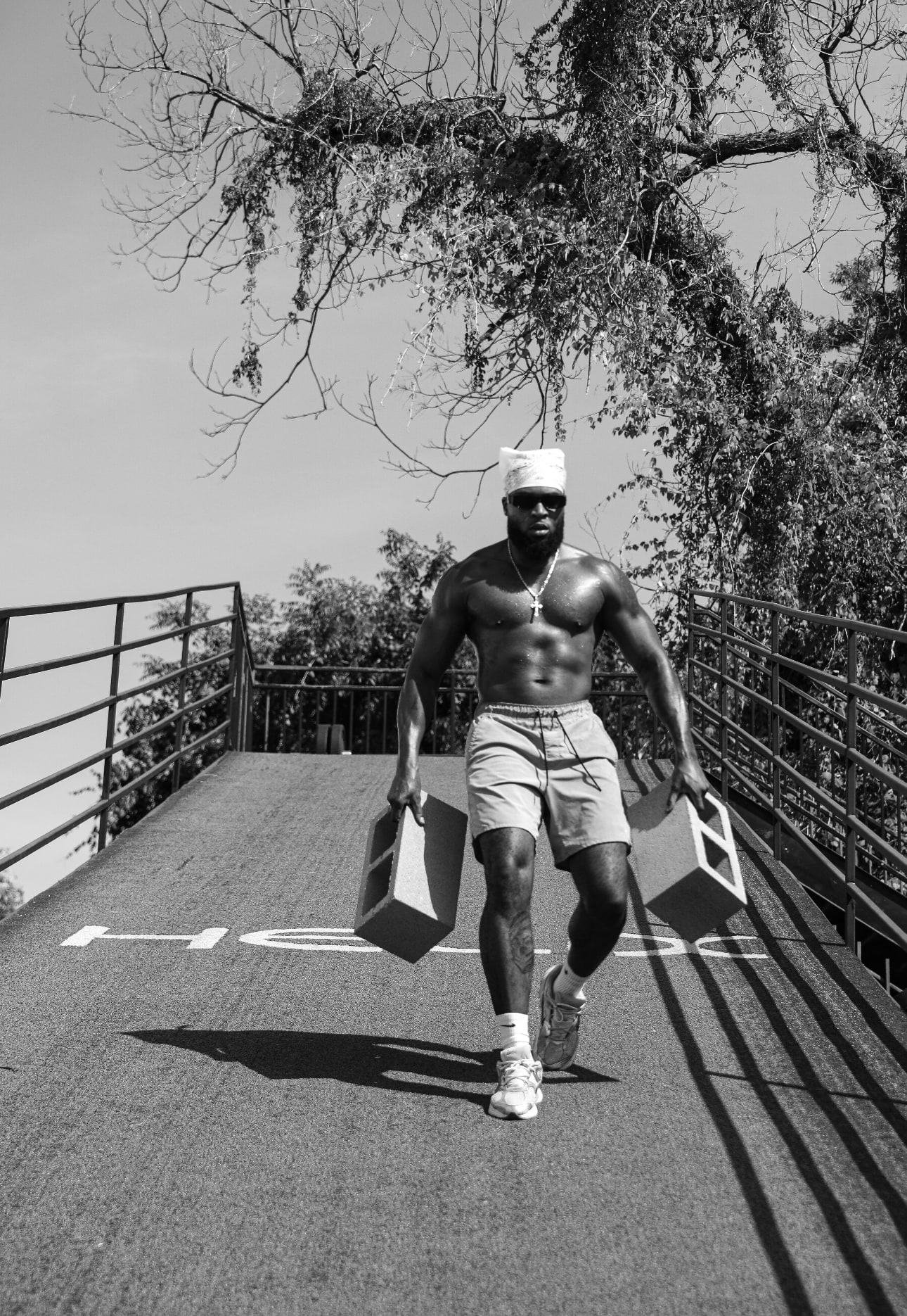 Lawrence carrying two training blocks along an outdoor ramp